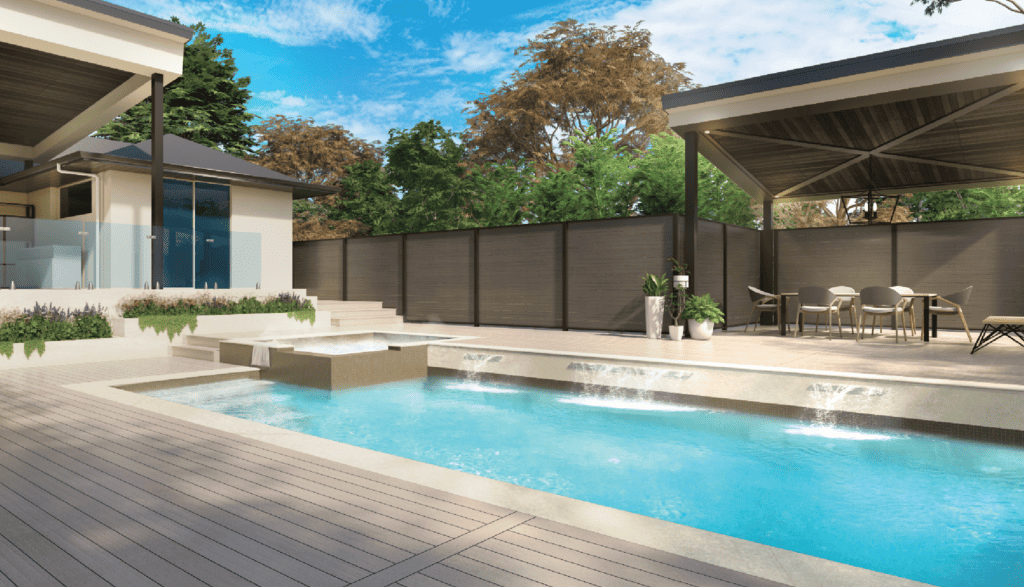 A swimming pool next to a patio and fence